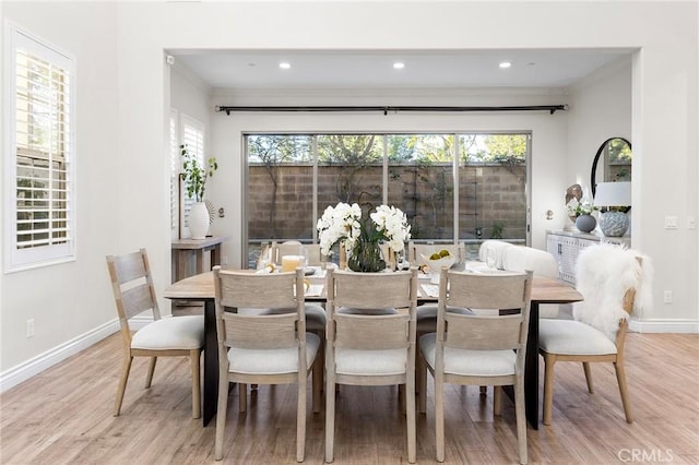 dining space featuring recessed lighting, wood finished floors, baseboards, and ornamental molding