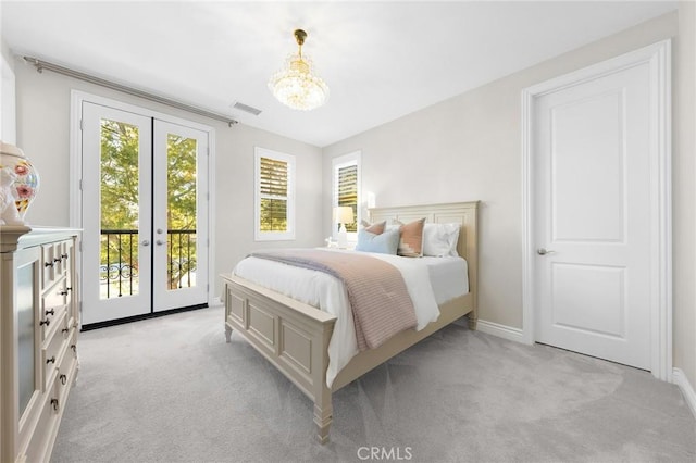 bedroom with light colored carpet, access to outside, visible vents, and french doors