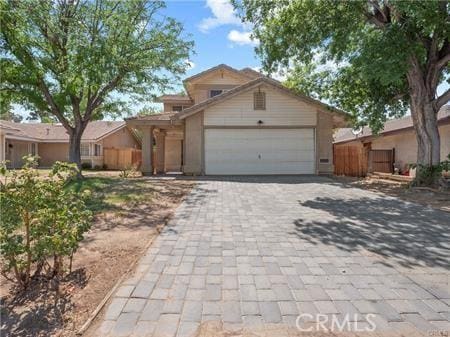 view of front of property with an attached garage and decorative driveway