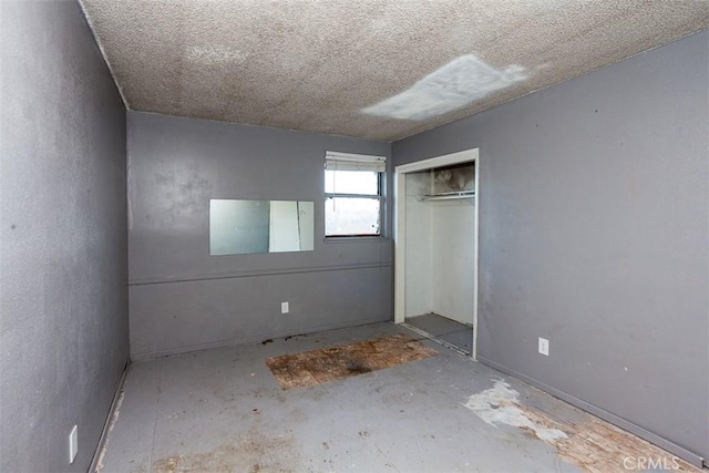 unfurnished bedroom with a closet and a textured ceiling