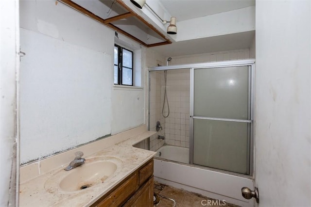 bathroom featuring enclosed tub / shower combo and vanity