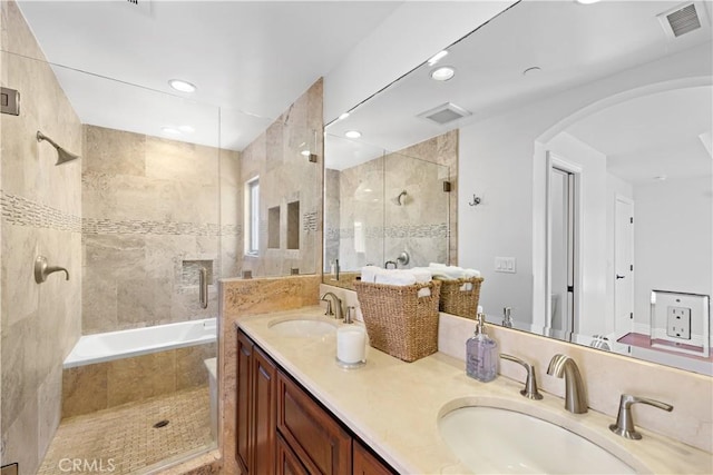 bathroom featuring recessed lighting, visible vents, a sink, and double vanity