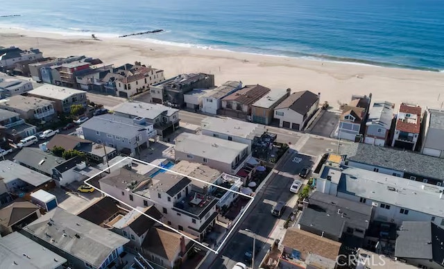 bird's eye view featuring a water view and a beach view