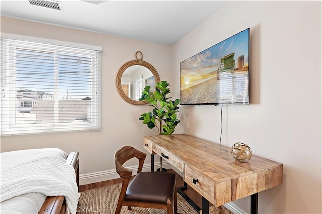 home office with visible vents, baseboards, and wood finished floors