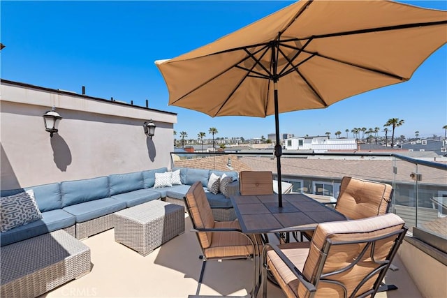 view of patio featuring outdoor dining area, outdoor lounge area, and a balcony