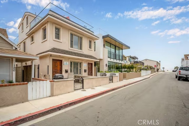 view of front of property featuring a fenced front yard and stucco siding