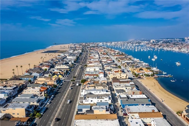 aerial view with a water view and a beach view