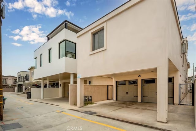 view of property with an attached garage and fence