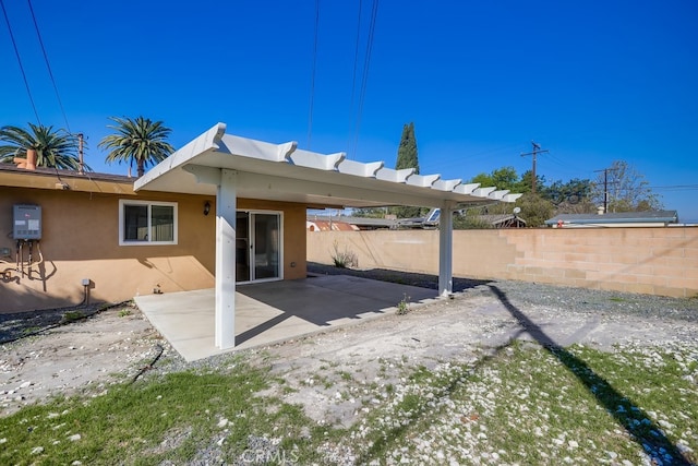 back of property with fence, a patio, and stucco siding