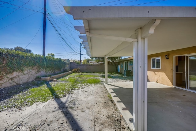 view of yard featuring a patio area, a fenced backyard, and central AC unit