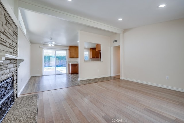 unfurnished living room with light wood-style flooring, recessed lighting, a large fireplace, visible vents, and a ceiling fan