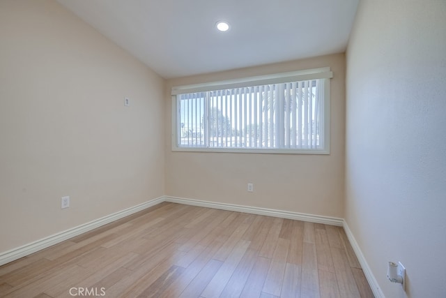 unfurnished room with baseboards, wood finished floors, and recessed lighting