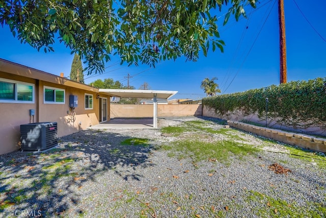 view of yard featuring central AC, a patio, and a fenced backyard