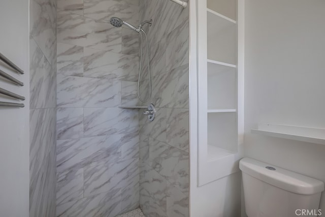 full bathroom with a stall shower and toilet