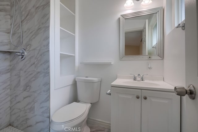 full bath with toilet, a tile shower, and vanity