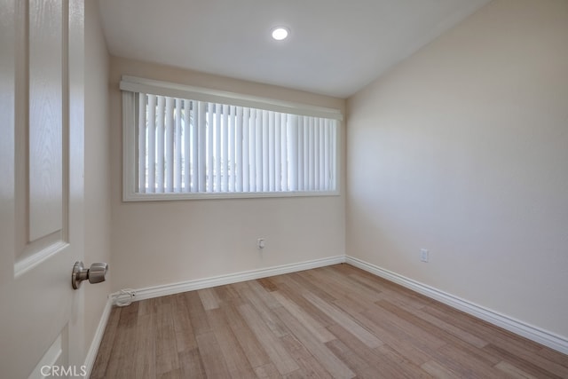 unfurnished room featuring recessed lighting, wood finished floors, and baseboards