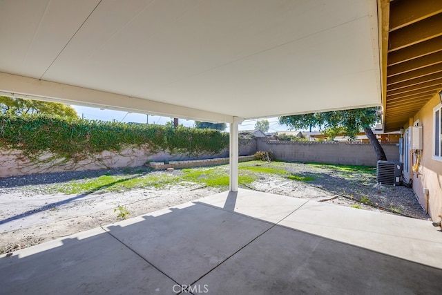 view of patio with fence and cooling unit