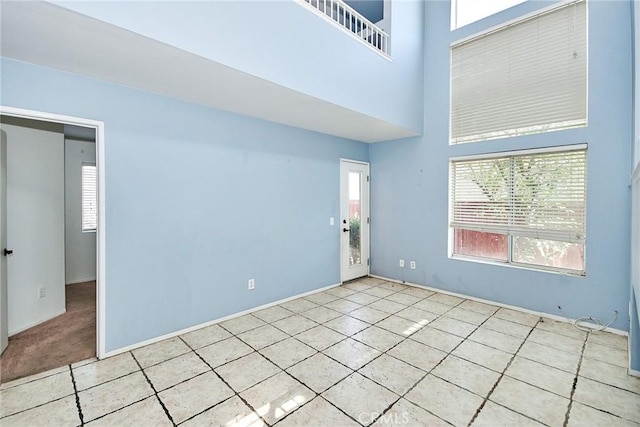 tiled empty room with a towering ceiling