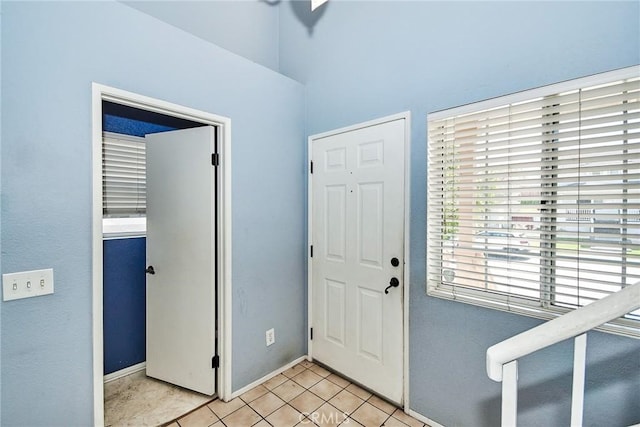 entrance foyer featuring baseboards and light tile patterned floors