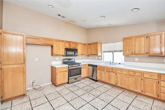 kitchen with recessed lighting, light countertops, visible vents, appliances with stainless steel finishes, and high vaulted ceiling