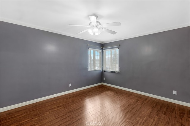 spare room with a ceiling fan, baseboards, and wood finished floors