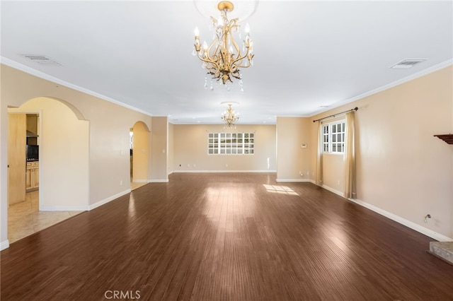 unfurnished living room featuring visible vents, baseboards, wood finished floors, arched walkways, and a notable chandelier