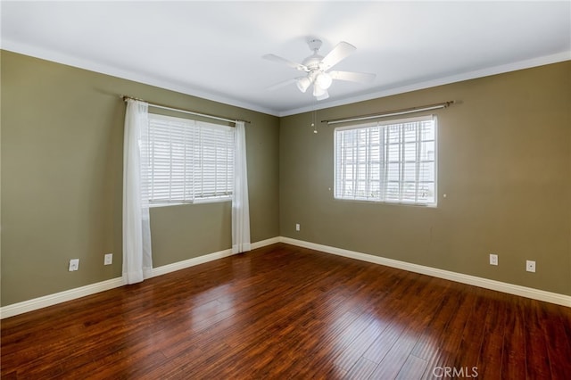 empty room with crown molding, baseboards, wood-type flooring, and ceiling fan