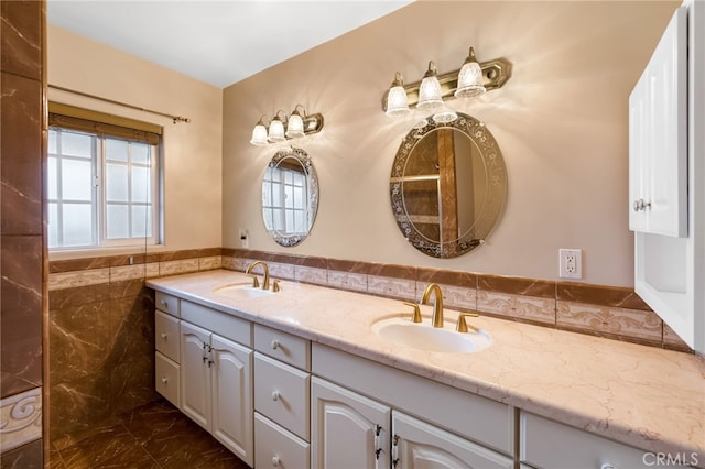 bathroom with double vanity, tile walls, and a sink