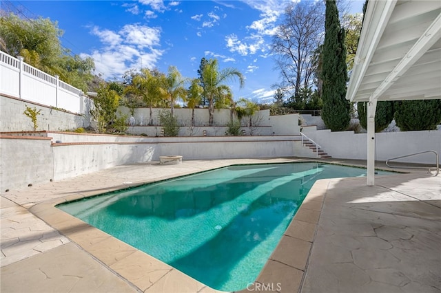 view of pool with a fenced in pool, a patio, and a fenced backyard