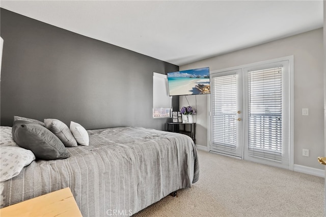 carpeted bedroom with access to exterior and baseboards