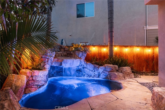 view of swimming pool with a jacuzzi