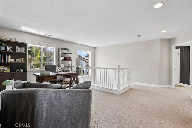 living room featuring recessed lighting, visible vents, light colored carpet, and baseboards