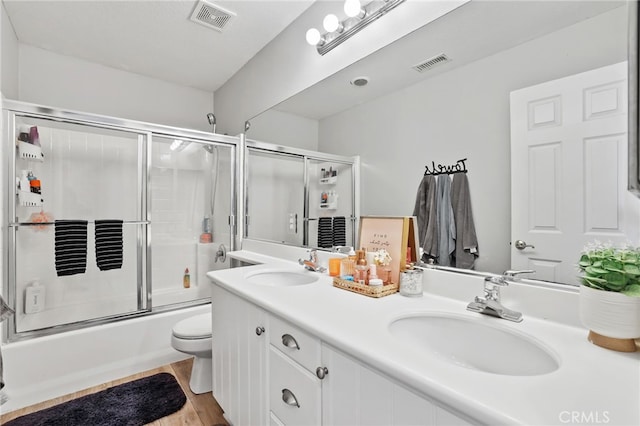 full bathroom featuring visible vents, toilet, and a sink