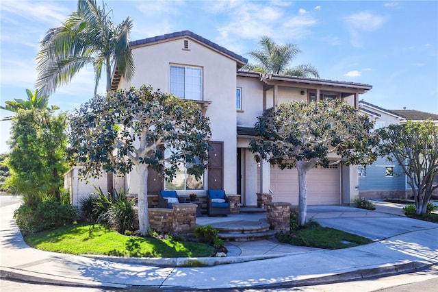 view of front facade with stucco siding, a garage, driveway, and a tiled roof