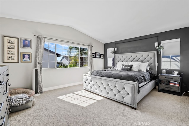 bedroom with multiple windows, baseboards, lofted ceiling, and carpet floors