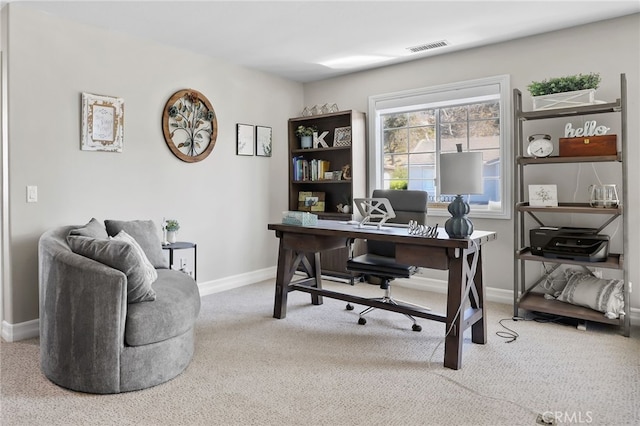 carpeted home office featuring visible vents and baseboards