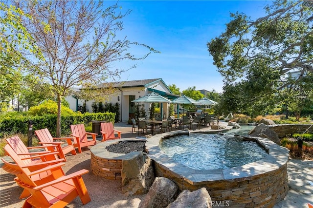 166 Natal Rd, Rancho Mission Viejo, CA 92694 - view of swimming pool with an outdoor fire pit, an outdoor hot tub, a patio, and outdoor dining area