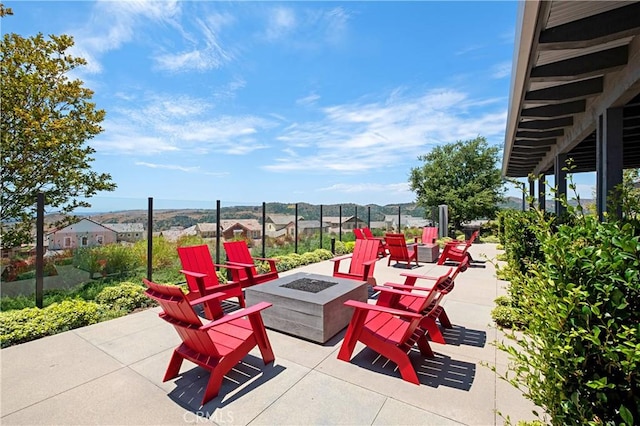 view of patio / terrace featuring fence and a fire pit