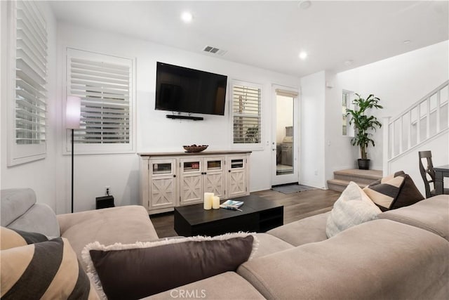 living room with baseboards, visible vents, stairway, dark wood-style flooring, and recessed lighting