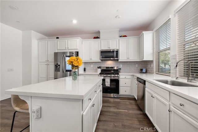 166 Natal Rd, Rancho Mission Viejo, CA 92694 - kitchen featuring stainless steel appliances, dark wood finished floors, a center island, tasteful backsplash, and recessed lighting