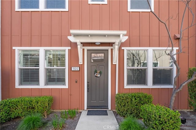 property entrance featuring board and batten siding