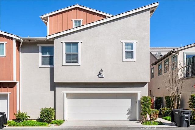 166 Natal Rd, Rancho Mission Viejo, CA 92694 - view of front of property with board and batten siding, stucco siding, a garage, and driveway