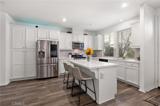 kitchen featuring stainless steel appliances, white cabinetry, and a sink