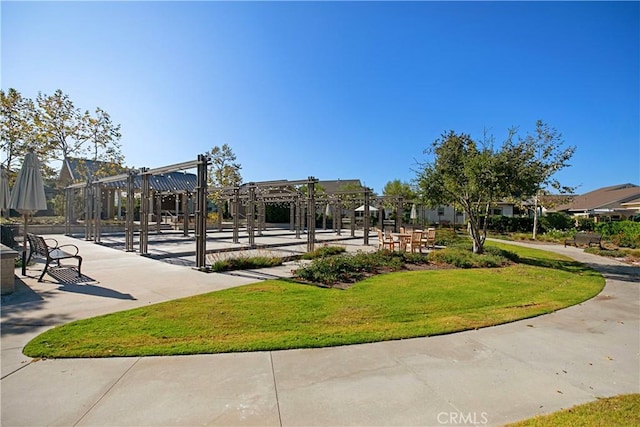 surrounding community with a yard and a pergola