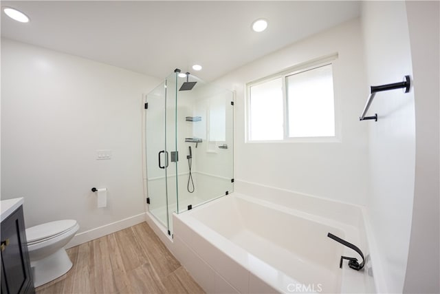 full bathroom featuring a garden tub, toilet, wood finished floors, vanity, and a shower stall