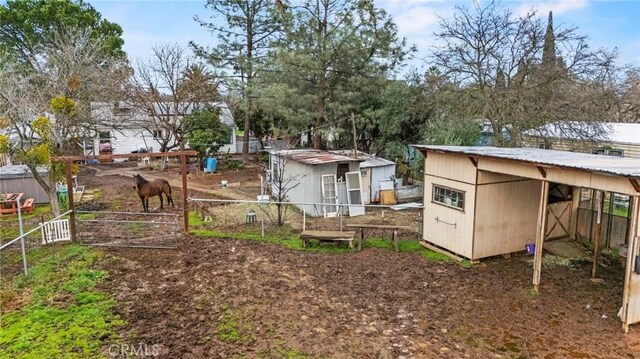 view of yard with fence and an outbuilding