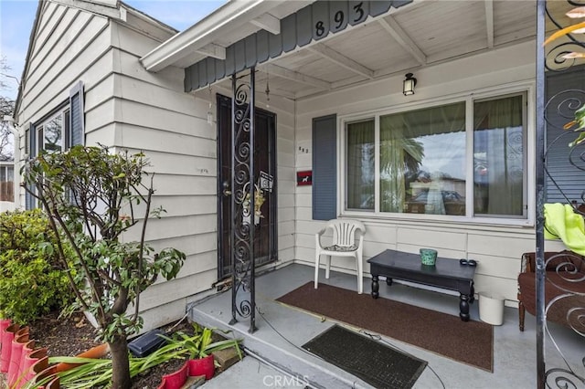 view of exterior entry with a porch