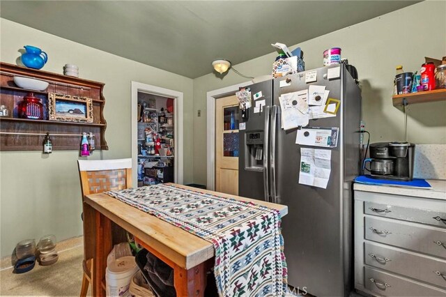 kitchen featuring stainless steel refrigerator with ice dispenser