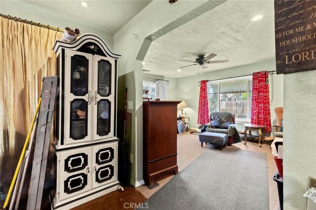 interior space with ceiling fan, a textured ceiling, a wealth of natural light, and recessed lighting