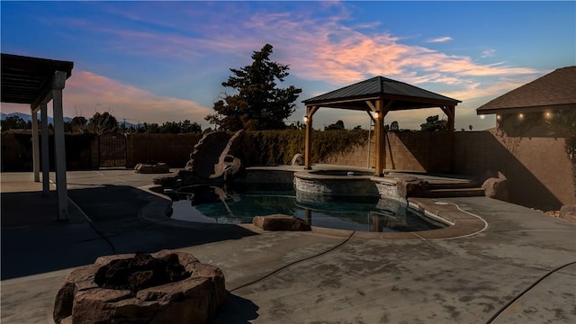 view of swimming pool featuring a fenced in pool, a gazebo, a fenced backyard, an in ground hot tub, and a patio